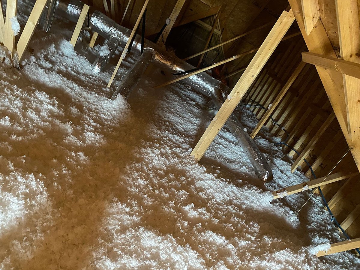 Old blown-in attic insulation ready for removal
