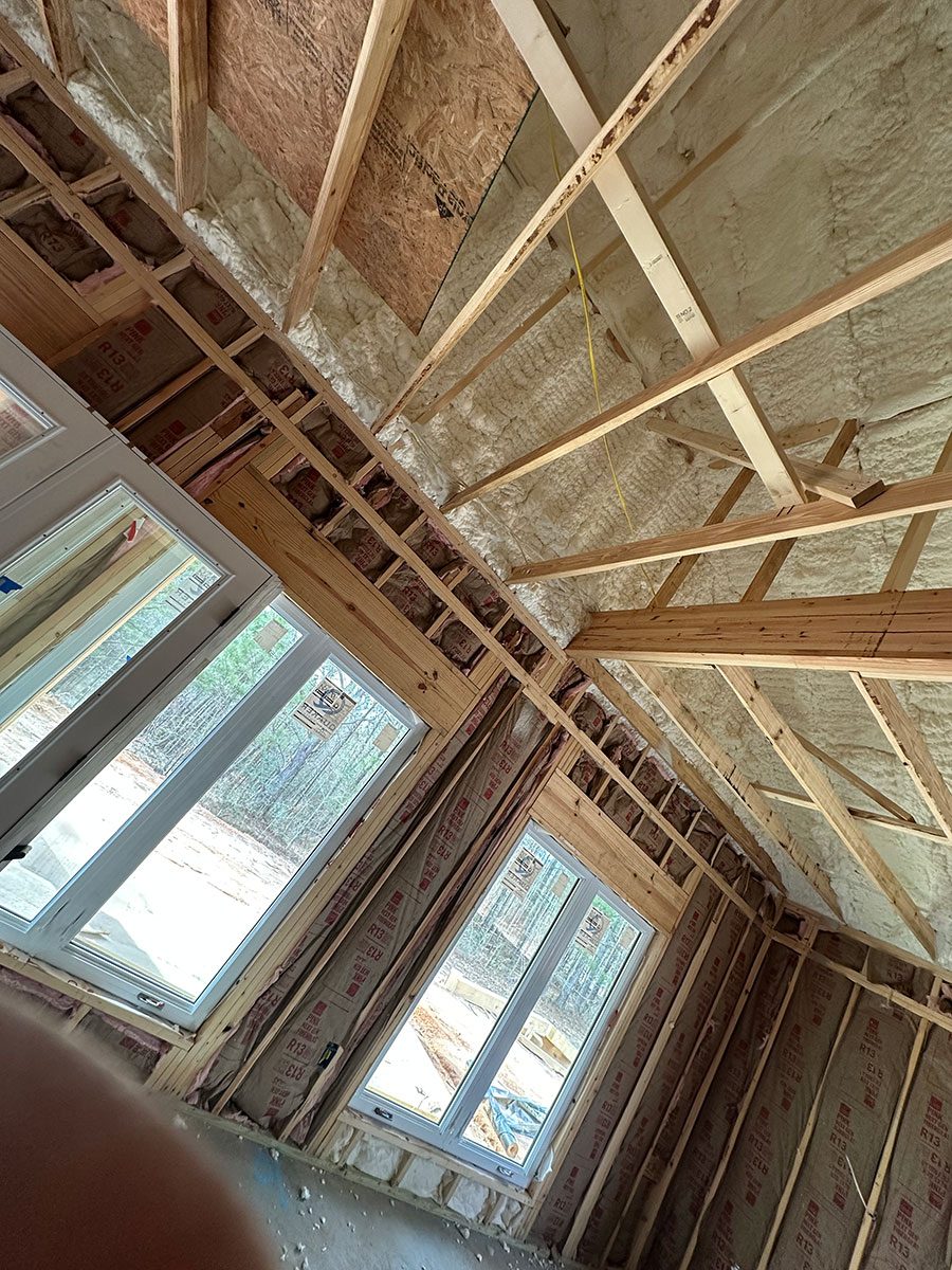 Open-cell spray foam ceiling with batt insulation walls