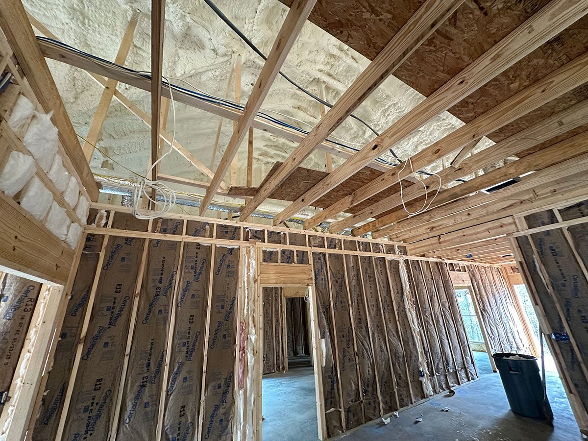 Combined open-cell spray foam and batt insulation installation