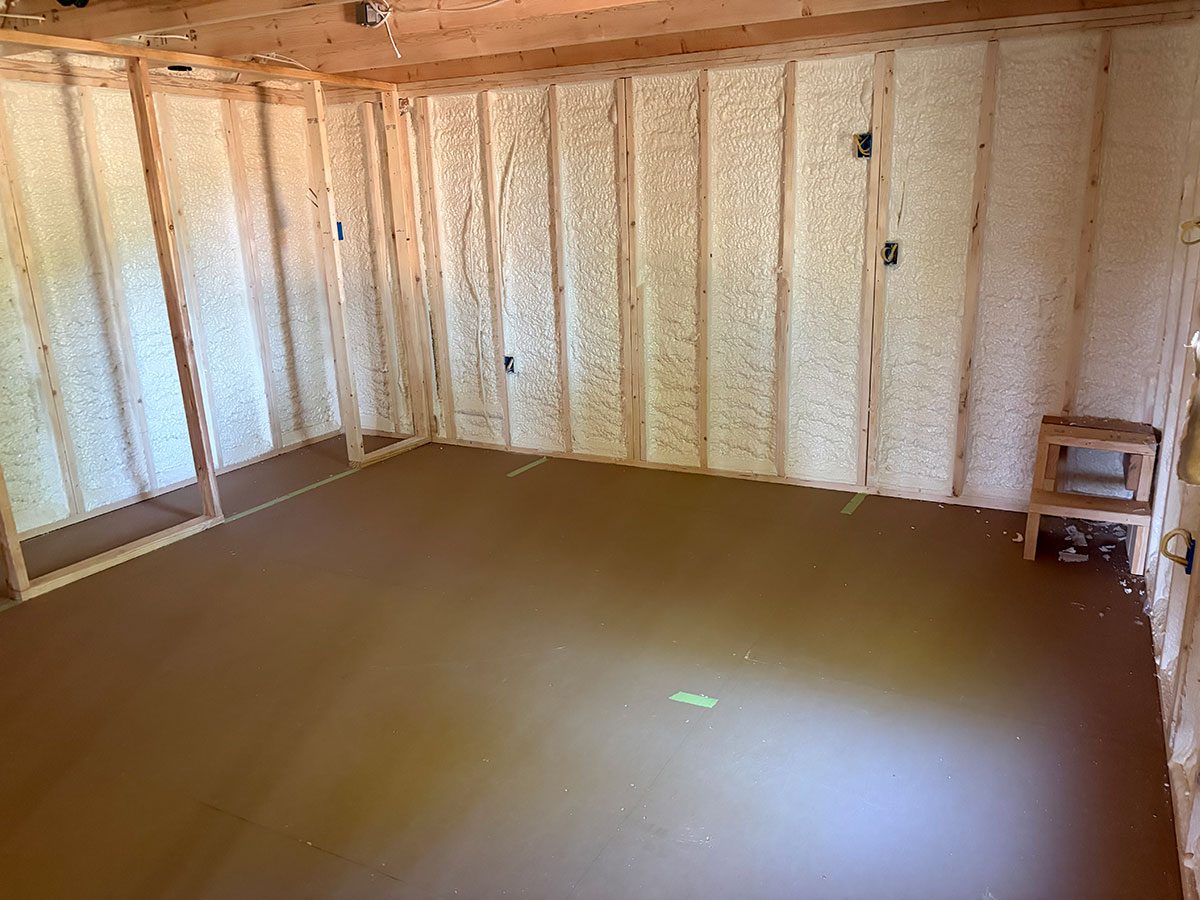 Open-cell spray foam ceiling insulation with framing exposed